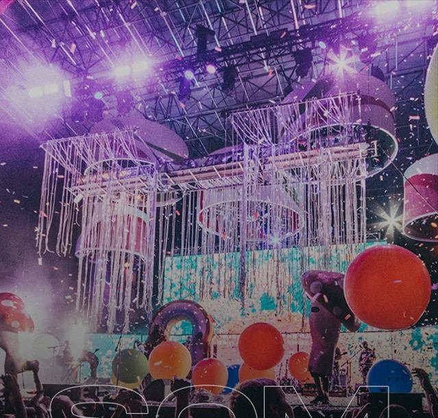 Palco com estrutura de iluminação, balões e chuva de papel
